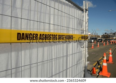 asbestos danger tape set up around a construction site