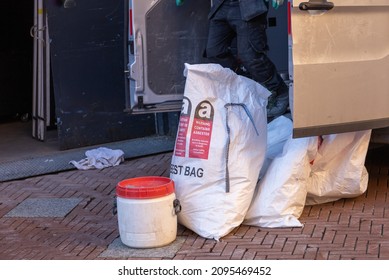 Asbestos removal, close up of bags. Text in english and french: warning, containing asbestos.  Toxic and hazzard, part of a serie. Asbestosis, part of a serie.