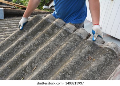 Asbestos removal roofer roof works. House with old, danger asbestos roof tiles repair and renovation.  Risks of Asbestos Roofs, Asbestos Roof Removal. 