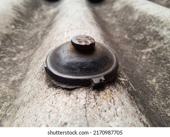 The Asbestos Roof Fasteners Look Dirty And Rusty.