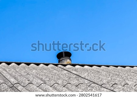 Asbestos slate roofing structure featuring chimney exhaust pipe ventilation