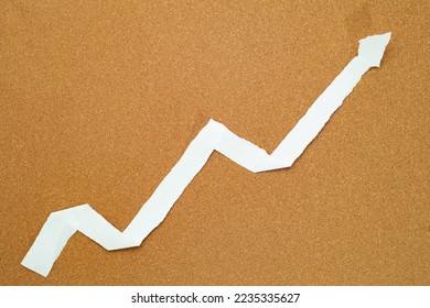 ascending graph made from paper strips on a cork board - Shutterstock ID 2235335627