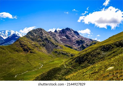 Ascent to the mountain top. Mountain under blue sky clouds. Mountain landscape. Mountain hill top
