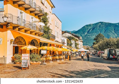 Ascona, Switzerland - August 23, 2016: People At Street Cafe In Romantic Luxury Resort In Ascona Town On Lake Maggiore, Ticino Canton In Switzerland. Outdoor Expensive Family Restaurants In Swiss City