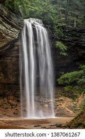 Ash Cave Falls, a beautiful waterfall in the Hocking Hills of Ohio, plunges from the top of an enormous sandstone recess cave after heavy spring rains.