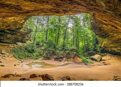 Ash Cave, a recess cave eroded from Blackhand sandstone in Ohio's Hocking Hills State Park, is about ninety feet high and seven hundred feet wide.