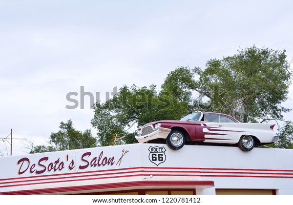 Ash Fork, Arizona - July 24,\
2017: DeSoto Salon in Ash Fork, Arizona, advertised itself by\
placing an actual 60s era Desoto Car on its roof, with Elvis\
driving. 