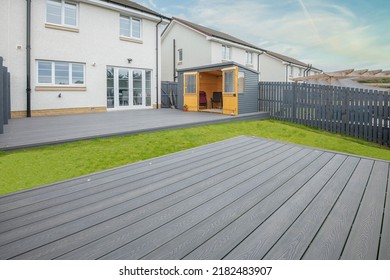 Ash Grey Composite Decking Built On Two Levels On A Residential Back Garden With Low Voltage Deck Lights Installed As Well. Good Image For A Landscape Gardiner