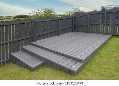 Ash grey composite decking built on two levels on a residential back garden with low voltage deck lights installed as well. Good Image for a landscape Gardiner - Shutterstock ID 2183128493