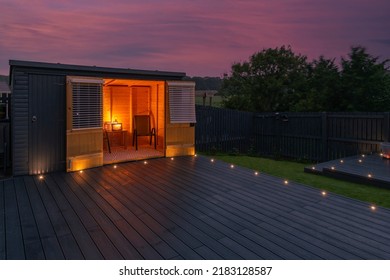 Ash grey composite decking built on two levels on a residential back garden with low voltage deck lights installed as well. Good Image for a landscape Gardiner - Shutterstock ID 2183128587