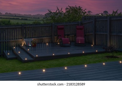Ash grey composite decking built on two levels on a residential back garden with low voltage deck lights installed as well. Good Image for a landscape Gardiner - Shutterstock ID 2183128589