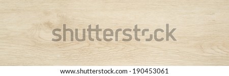 Ash wood texture background, light wood plank close-up. Long wooden board or laminate for flooring, top view. Abstract wood panel or veneer with natural pine pattern and color.