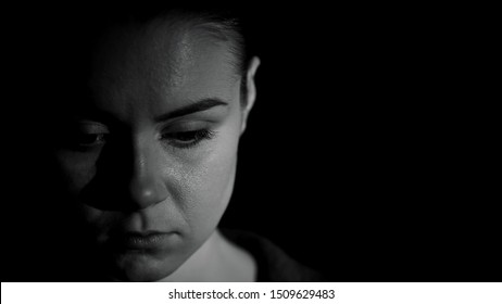 Ashamed Woman Looking Down Against Dark Background, Humiliation Victim, Kidnap