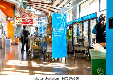 Ashburn, USA - February 2, 2020: Whole Foods Interior In Virginia With Prime Now Fresh Delivery And Employess Stocking Bags With Produce By Blue Sign Banner