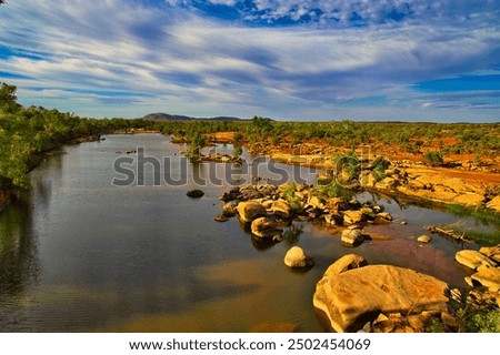 The Ashburton River at Nanutarra, Pilbara region, Western Australia. The red earth of the outback lights up in the setting sun

