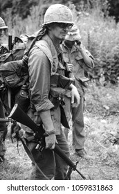 Ashdown Forest Kent UK 2001. An Unidentified Reenactor Of The Vietnam War Wears The Period Uniform Of A US Rifleman He Stands M16 Rifle In Hand At A Re-enactment Of A Battle Of Dewey Canyon 1968.