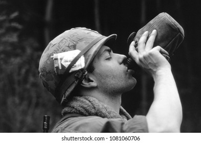 Ashdown Forest Kent UK 2002. An Unidentified Reenactor Of The Vietnam War Takes A Drink Form A Water Bottle And Wears The Uniform Of A US Rifleman At A Re-enactment Of The Battle Of Dewey Canyon 1968.