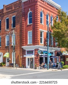 ASHEBORO, NC, USA-26 SEPT 2022: Street Corner View Of Historic Building Hosing The Taco Loco, Showing People Seated On Sidewalk.