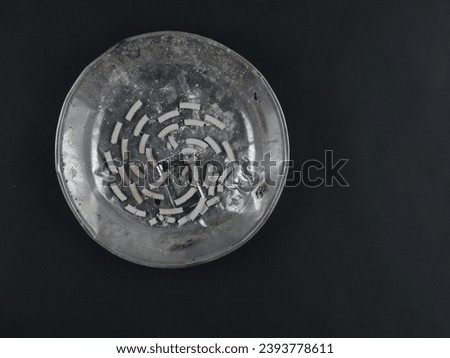 ashes of mosquito coils in a plate isolated on black background