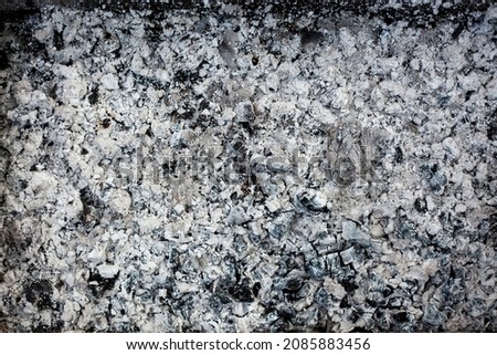 Ashes texture blurred background. Wood ash in fireplace. Defocused charcoal cinder textured. Blurred image black and white background. Close up. defocused