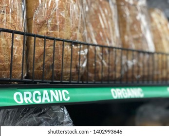 Asheville, NC / USA - May 20, 2019: Loaves Of Organic Bread Are On Display With A Sign On The Rack That Says 