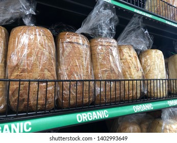 Asheville, NC / USA - May 20, 2019: Loaves Of Organic Bread Are On Display With A Sign On The Rack That Says 