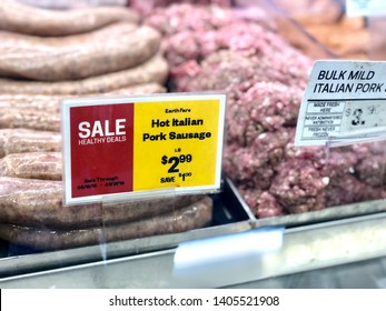 Asheville, NC / USA - May 21, 2019: This Is A Color Photo Of Bulk Hot Italian Sausage On Display In A Meat Department Case Showing The Sale Sign.