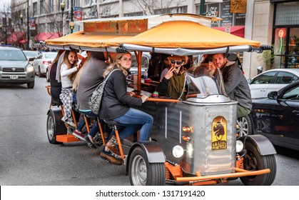 ASHEVILLE, NC, USA-2/16/19: A 13 seater pedal-powered touring vehicle transports tourists around town, with stops at pubs en route.