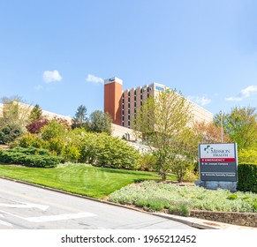ASHEVILLE, NC, USA-25 APRIL 2021: Mission Health Emergency entrance, St. Joseph Campus, Asheville Specialty Hospital.  Information road sign and building.