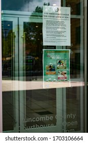 Asheville, North Carolina - 13 April 2020: Signs at the entrance to the Buncombe County Courthouse restricts who may enter during the Covid-19 pandemic.
