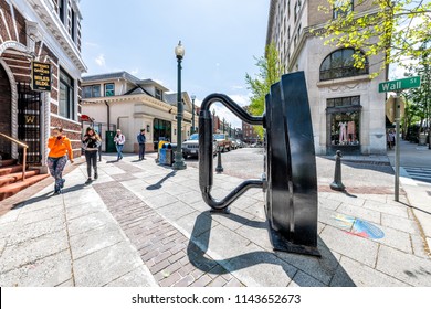 Asheville, USA - April 19, 2018: Asheville Iron Sculpture at Wall street shopping mall with people walking