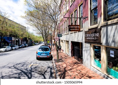 Asheville, USA - April 19, 2018: Sign for Cornerstone minerals jewelry store shop with people walking on street sidewalk in North Carolina downtown city