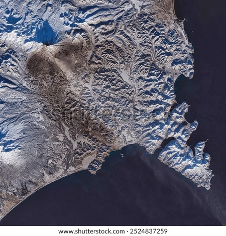 Ashfall on Zhupanovsky Volcano. Explosive events continued at a Russian volcano, turning white snow grey with ash. Elements of this image furnished by NASA.