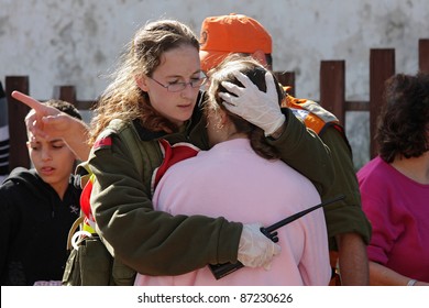 ASHKELON - JANUARY 10: Israeli Soldier From Rescue Team Hugs Woman Who Witnessed A Missile Launched By Hamas Terrorists From Gaza Explode Near Her House On January 10, 2009 In Ahskelon, Israel.