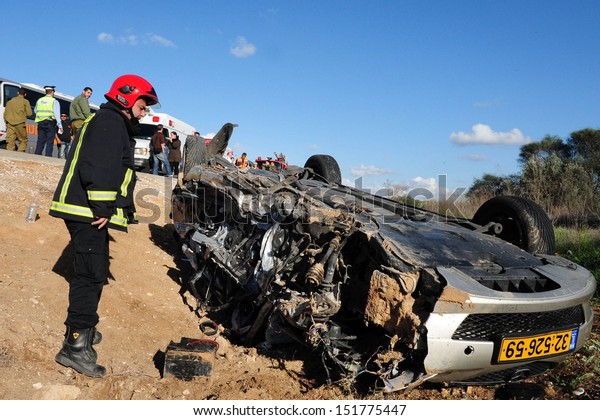 ASHKELON,ISR - FEB 01:Firefighter in a deadly car\
accident scene on Feb 01 2009.According to the World Health\
Organization:1.2M people are killed in traffic accidents each year\
around the world
