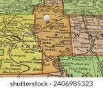 Ashland County, Ohio marked by a white tack on a colorful vintage map. The county seat is located in the city of Ashland, OH.