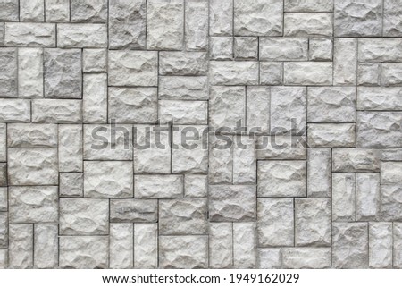 Ashlar wall. The stone is rectangular. Grey colour.