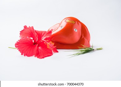 Ashtavinayaka Or Ganapati Or Ganesha Idol With Hibiscus Or Jasvand Flower, Isolated Over White Background