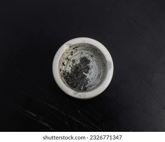 ashtray and cigarette ashes on a black background