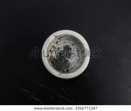 ashtray and cigarette ashes on a black background