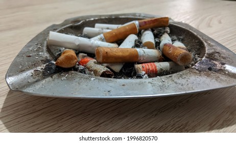 Ashtray full of cigarette residue from a very active smoker.