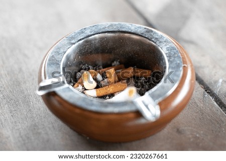The ashtray used for receptacle the tobacco ash and cigarette butts in smoking area