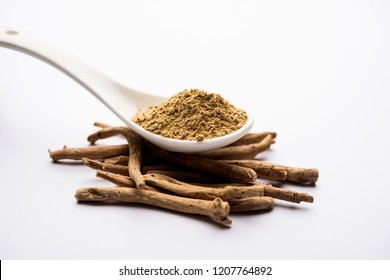 Ashwagandha / Aswaganda OR Indian Ginseng is an Ayurveda medicine in stem and powder form. Isolated on plain background. selective focus
