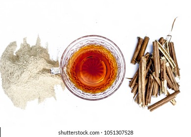 Ashwagandha Roots And Its Powder Also Known As Indian Ginseng, Isolated On White Essential Beneficial For Hair Loss With Its Organic Tea Made From Its Powder.