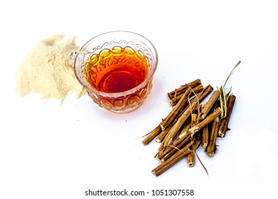 Ashwagandha Roots And Its Powder Also Known As Indian Ginseng, Isolated On White Essential Beneficial For Hair Loss With Its Organic Tea Made From Its Powder.