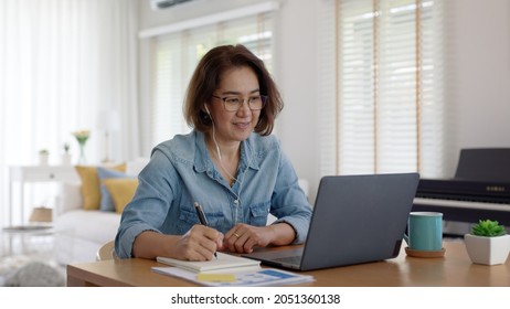 Asia adult happy people or sme owner latin lady sit consult talk in online seminar reskill upskill job discuss class for worker on desk table work at home in remote teach advice by digital training. - Shutterstock ID 2051360138