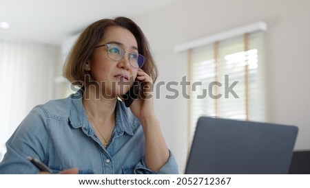 Asia adult people or SME owner woman leader moody sitting tired busy phone call work on laptop computer at desk house office think worry concern give advice on distance job crisis corporate trouble.