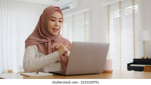 Asia arab people young woman wear hijab headscarf plan study MBA college class note idea data in sale report remote work at home on laptop. Happy advisor lifestyle smile cowork smart workforce job. - Powered by Shutterstock