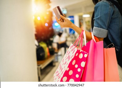 Asia Beautiful Woman Carrying Shopping Bag And Walking In The Department Store.young Lady Shopping By Using Credit Card On Weekend.