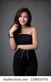 Asia beautiful woman wear dress pants black. Standing in front of a black background.